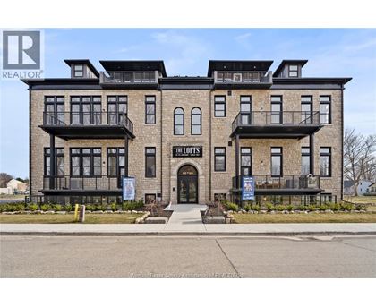 A building with the sign "The Lofts" in front of it.