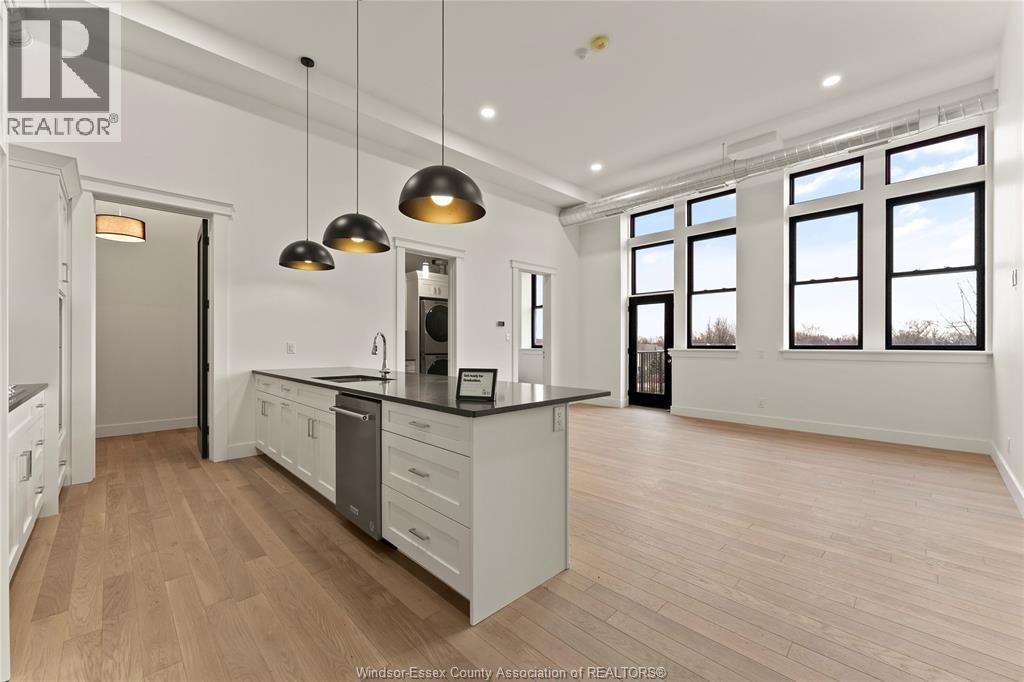 A well-lit kitchen with wooden floors and a large island.