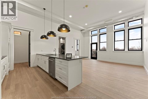 A well-lit kitchen with wooden floors and a large island.