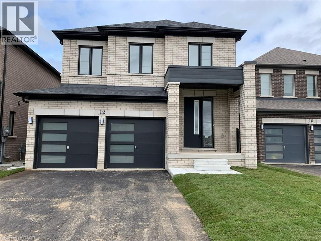 A modern two-story house with a garage on the ground floor.