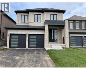 A modern two-story house with a garage on the ground floor.