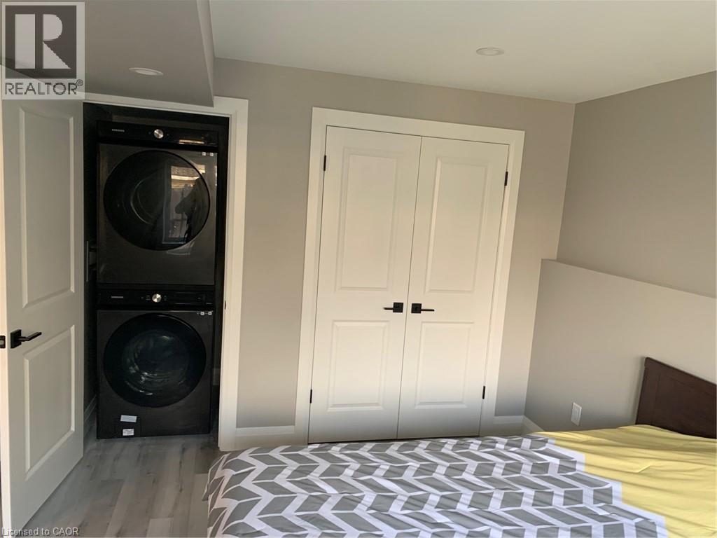 A bedroom with a bed and a window.