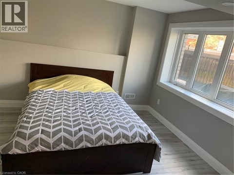 A bedroom with a bed and a window.