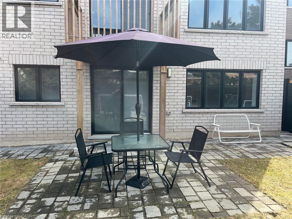 A table with chairs and an umbrella is set up outside a building.