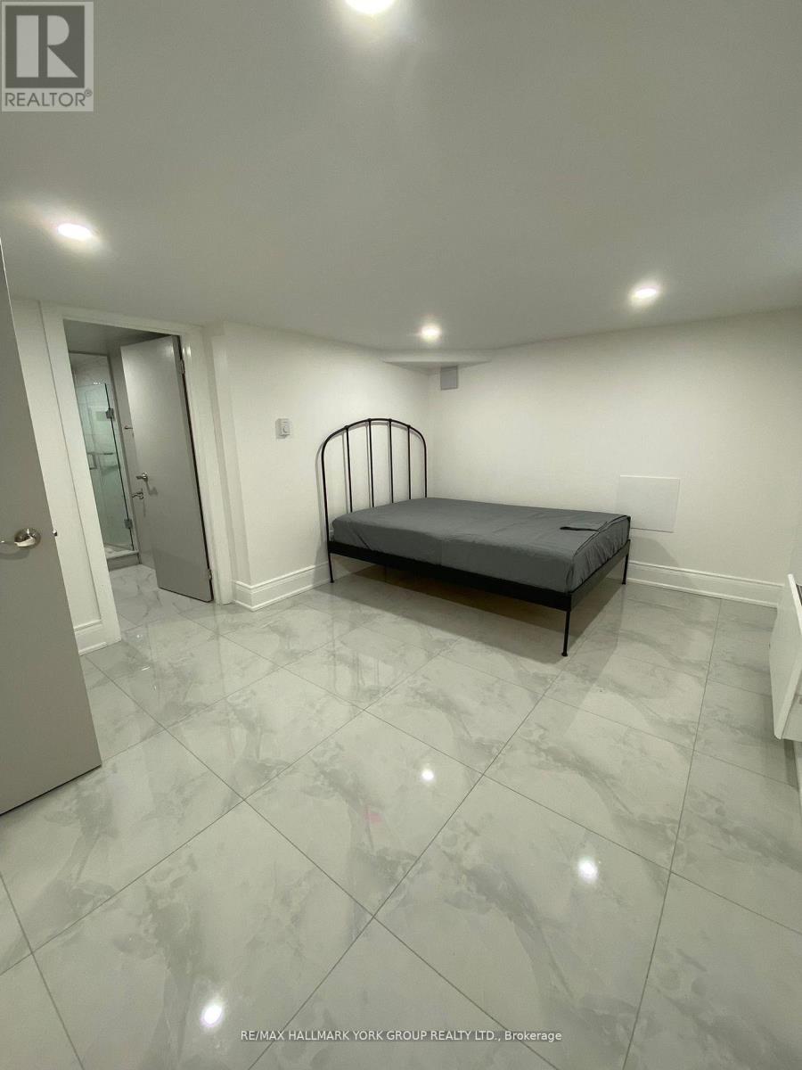 A bedroom with a bed, dresser, and mirror.