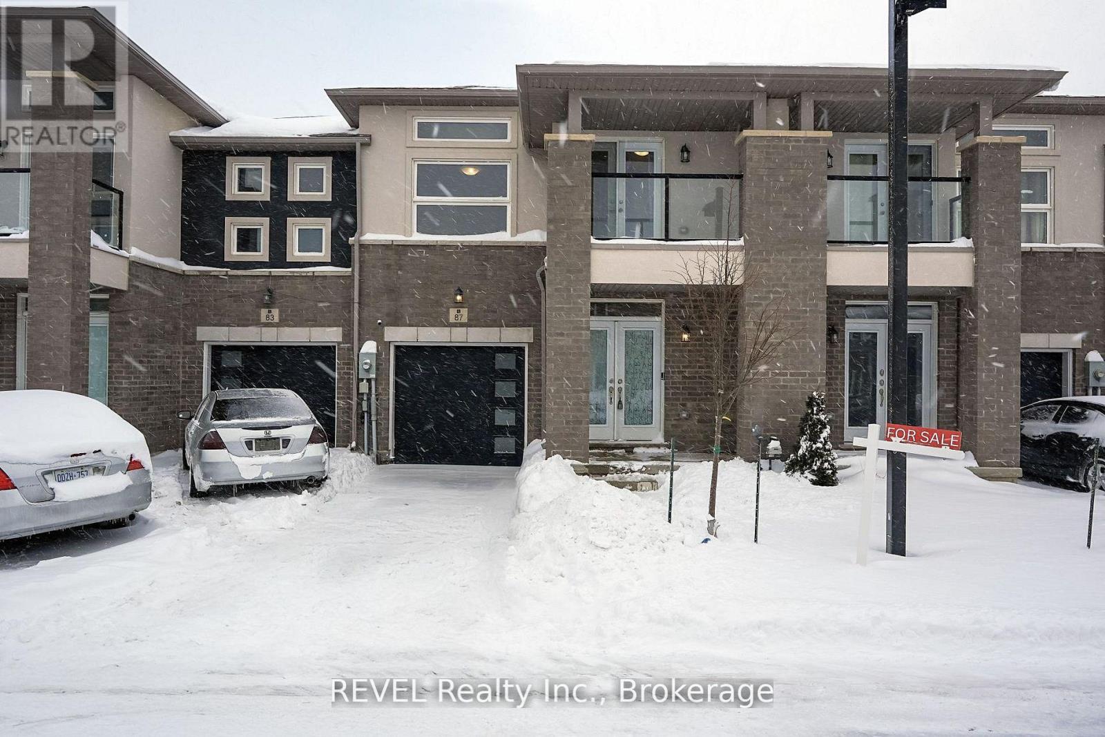 A snowy scene with a house and a car in the foreground.