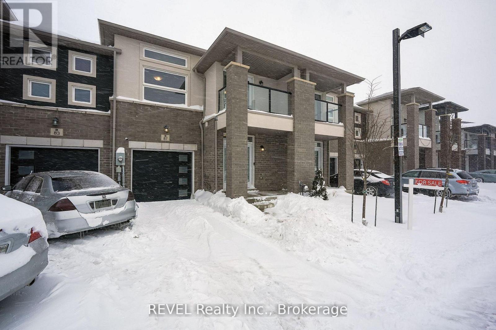 A snow-covered street with a house and a car parked in front.