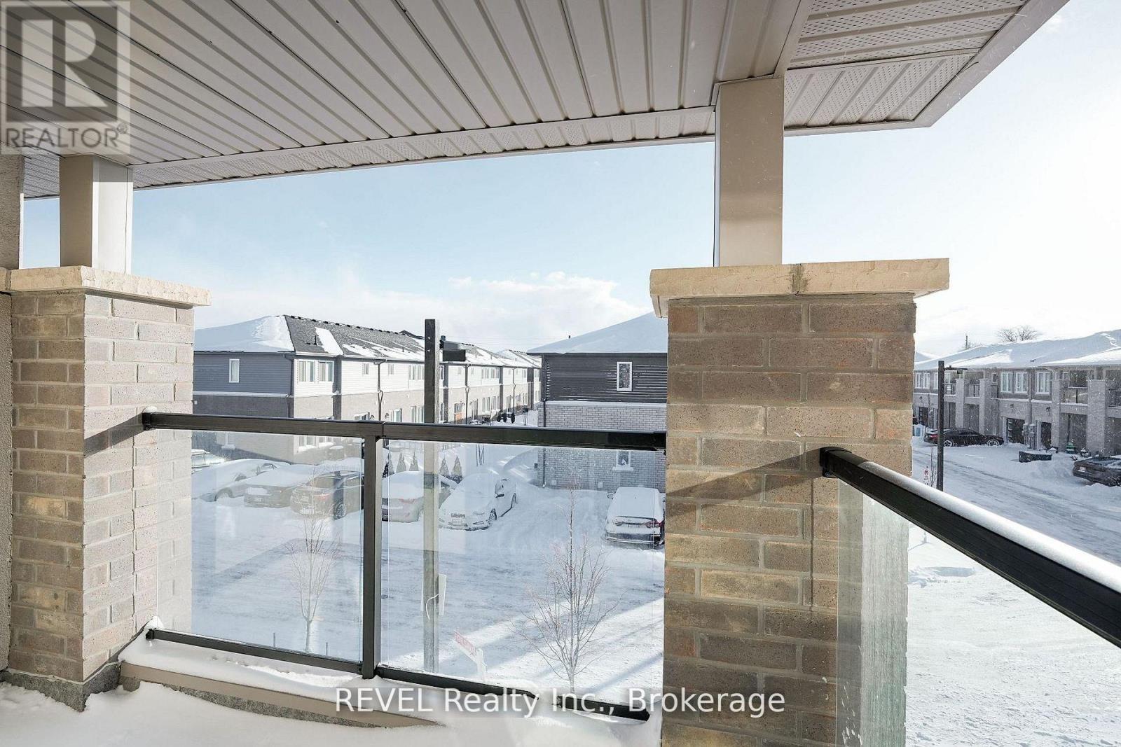 A balcony with a view of a snowy landscape and buildings.