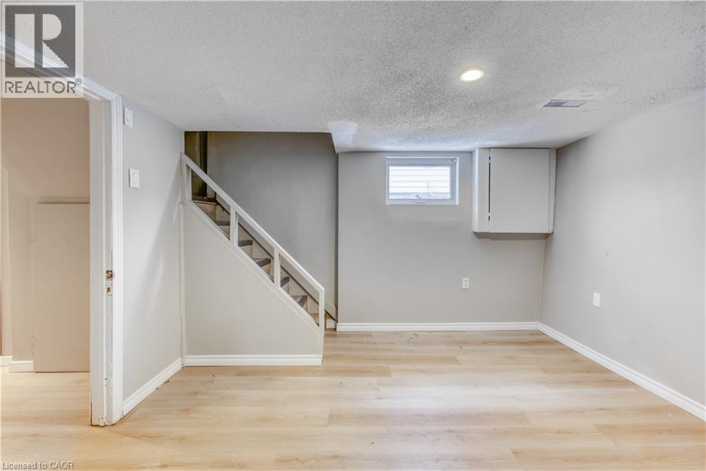 A room with a staircase leading to another room.