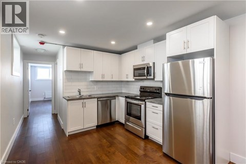 A kitchen with white cabinets and stainless steel appliances.