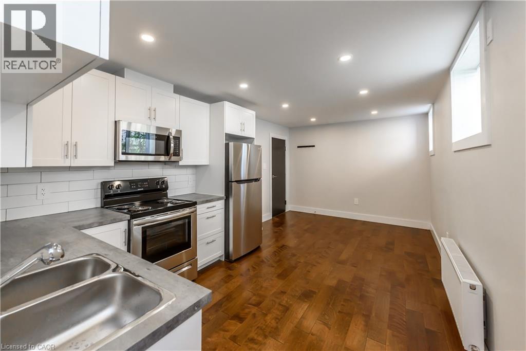 A kitchen with a stove, oven, and refrigerator.