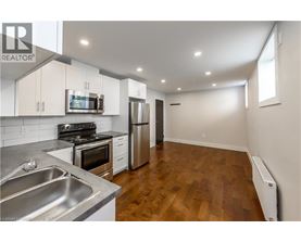 A kitchen with a stove, oven, and refrigerator.