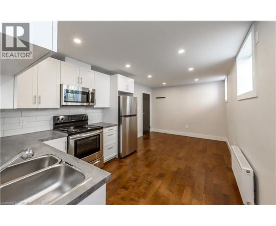 A kitchen with a stove, oven, and refrigerator.