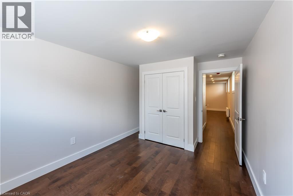 A white door is in a hallway with wood floors.