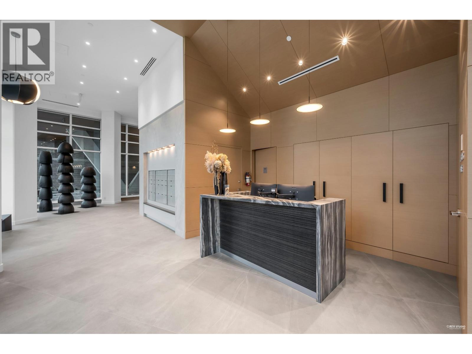 A modern office space with a reception desk and a logo that reads "REALTOR".