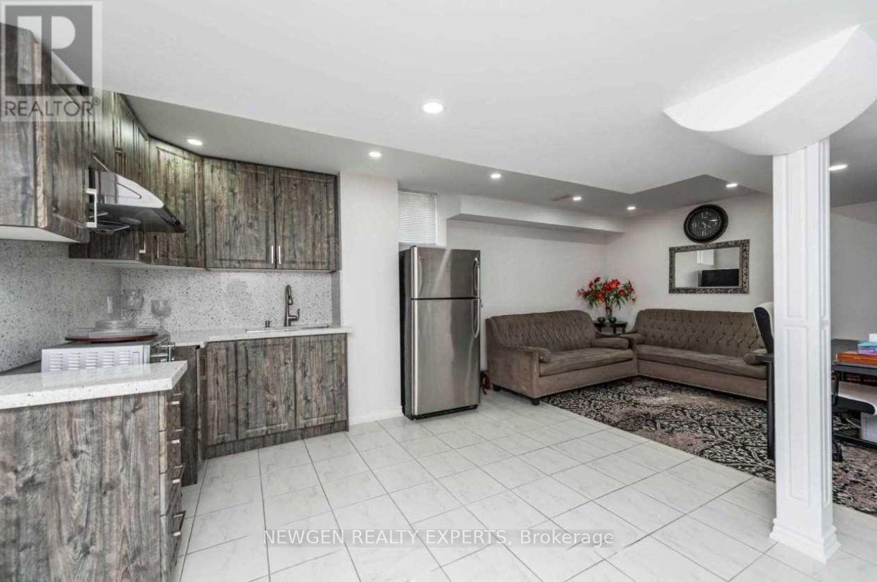 A kitchen with a refrigerator, a sink, and a counter.