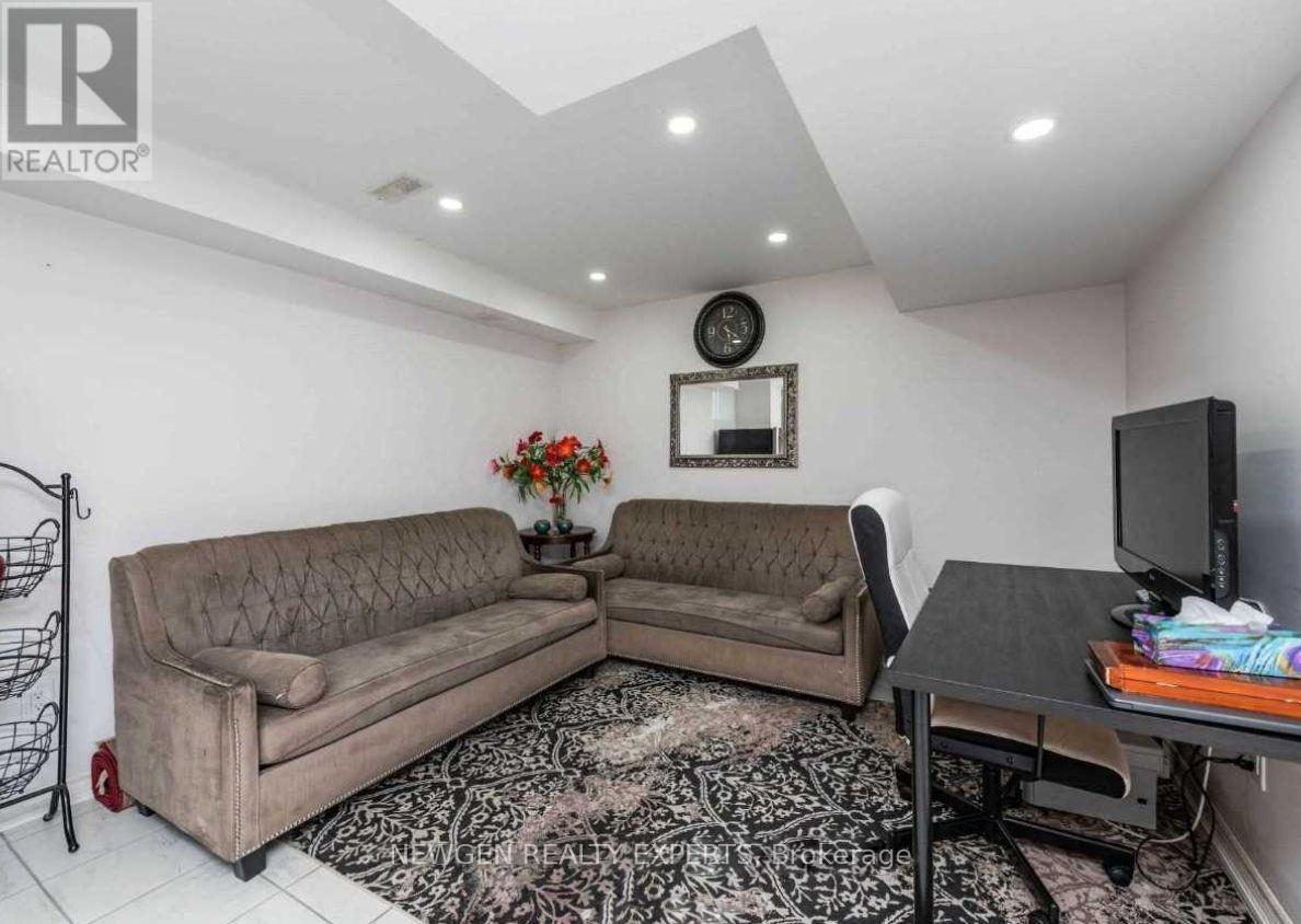 A living room with a couch, a chair, a table, and a television.