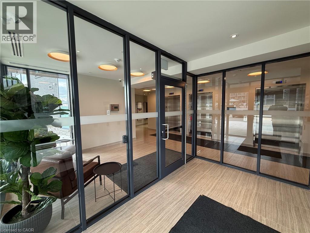A glass door with a black mat in front of it.