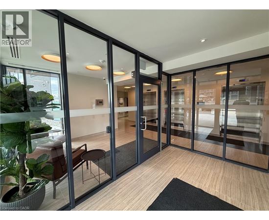 A glass door with a black mat in front of it.