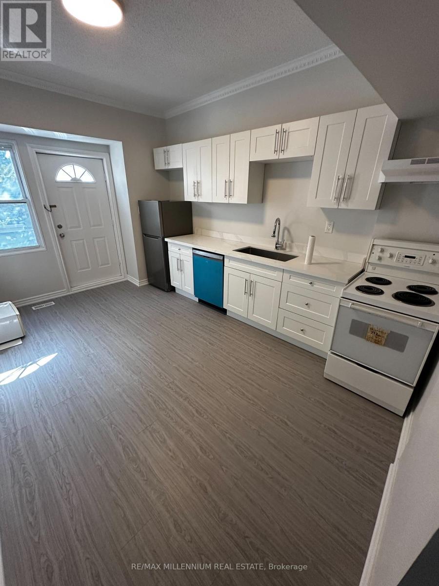 A kitchen with white cabinets and a blue island.