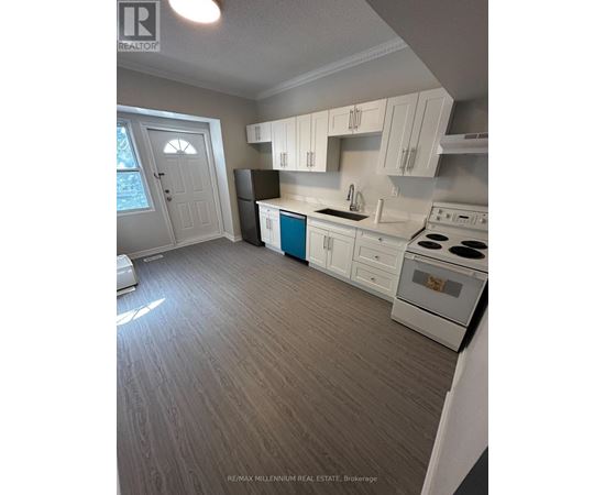 A kitchen with white cabinets and a blue island.