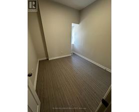 A room with a wooden floor and white walls.