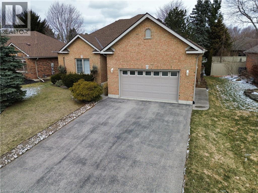 A house with a garage and driveway in front.