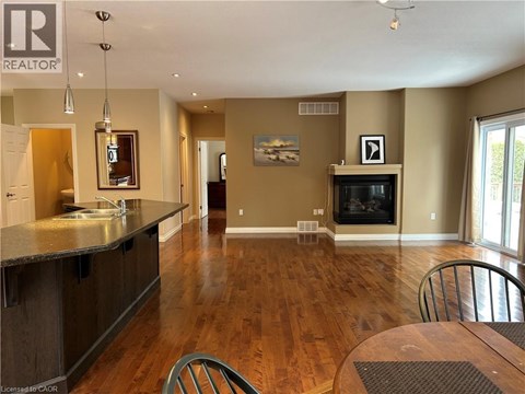A well-lit kitchen with a dining table and chairs.