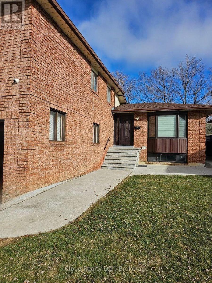 A brick building with a brown door and windows.