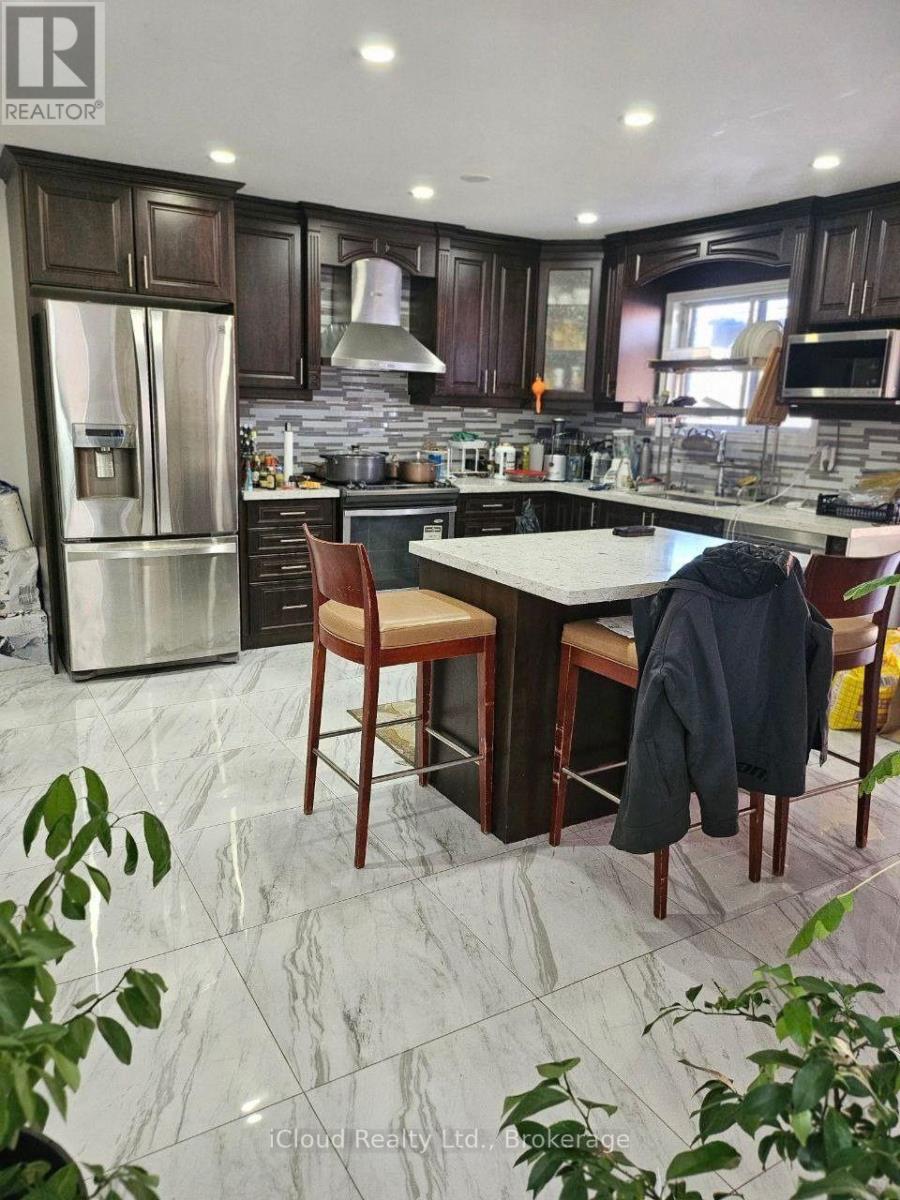 A kitchen with a marble floor and a table with chairs.