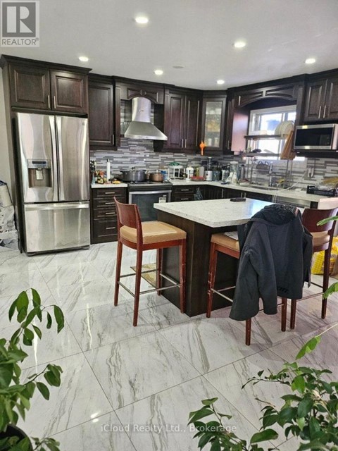 A kitchen with a marble floor and a table with chairs.