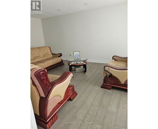 A living room with a sofa, chair, and coffee table.