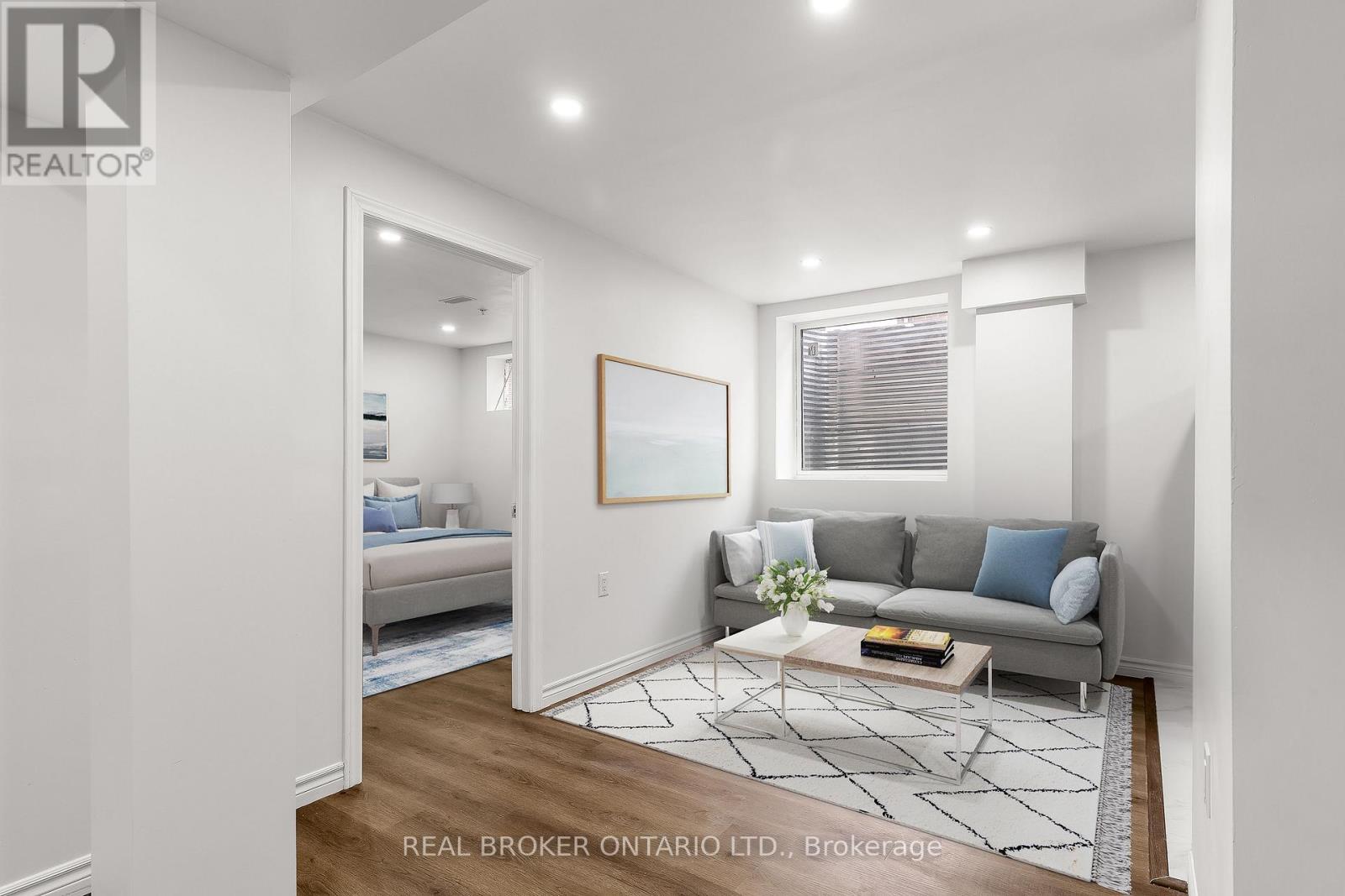 A living room with a grey couch and a coffee table.