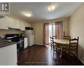 A kitchen with a dining table and chairs in the middle of the room.