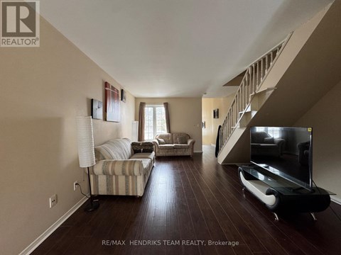 A living room with a striped couch and a television.