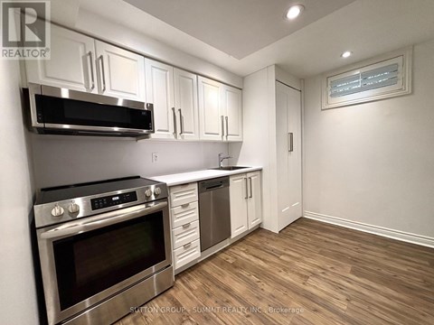 A kitchen with white cabinets and stainless steel appliances.