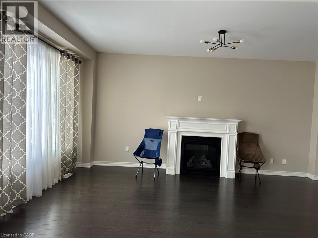 A living room with a fireplace and a chair.