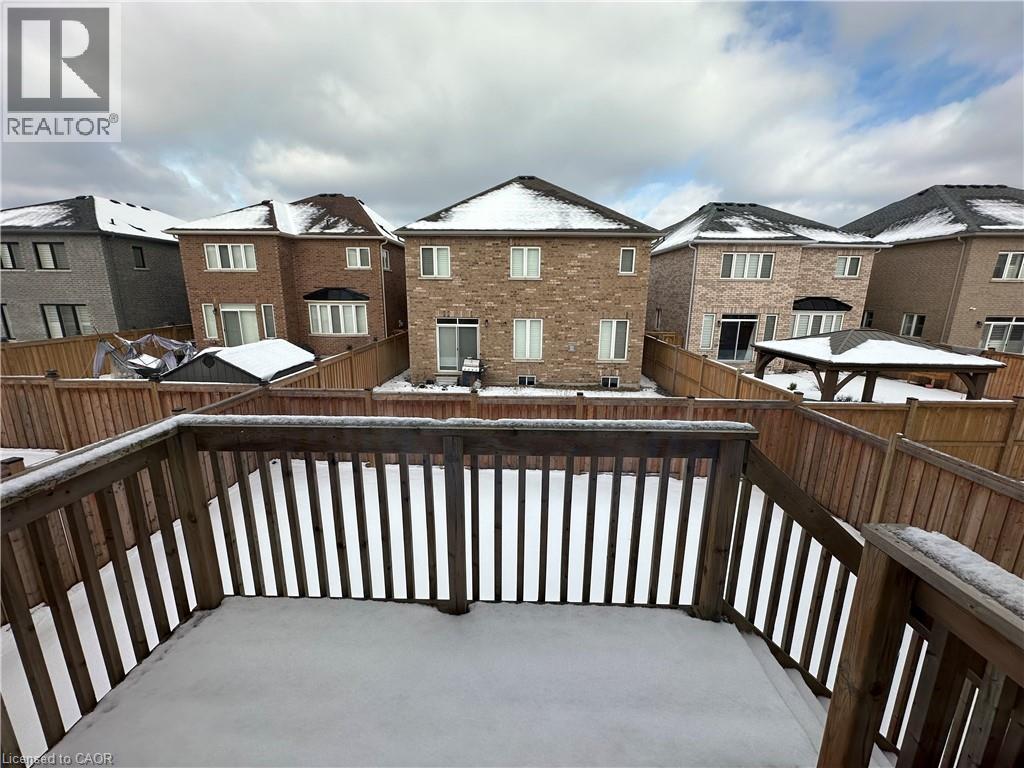 A snow-covered deck with a view of apartment buildings.