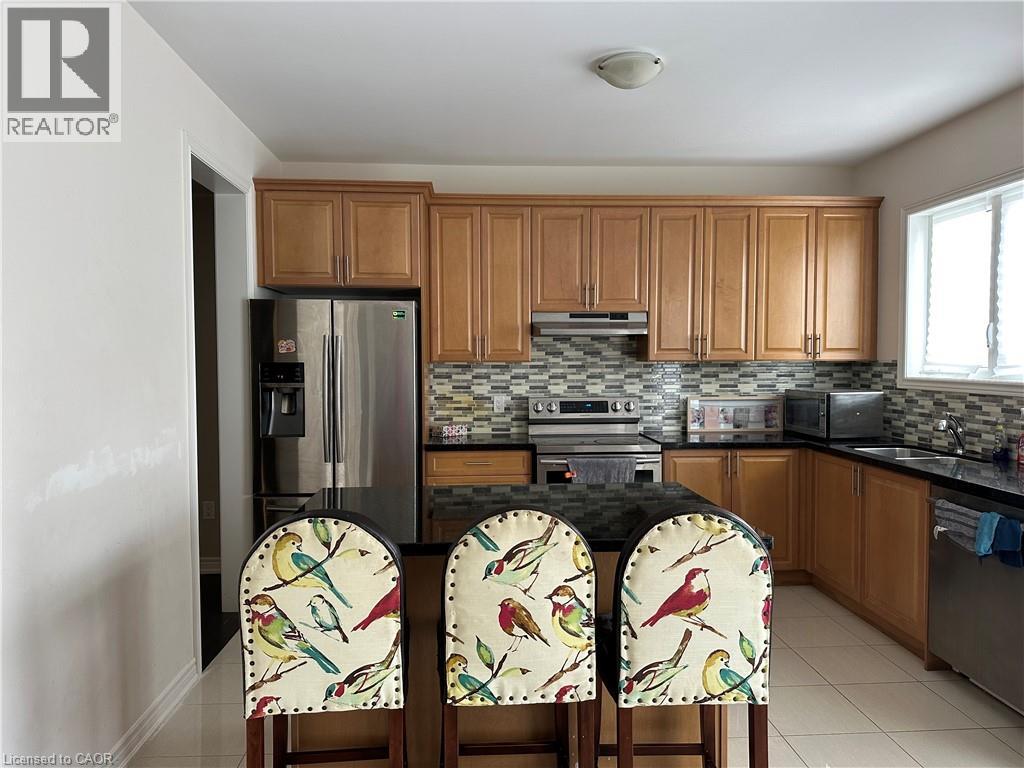 A kitchen with wooden cabinets and a black countertop.