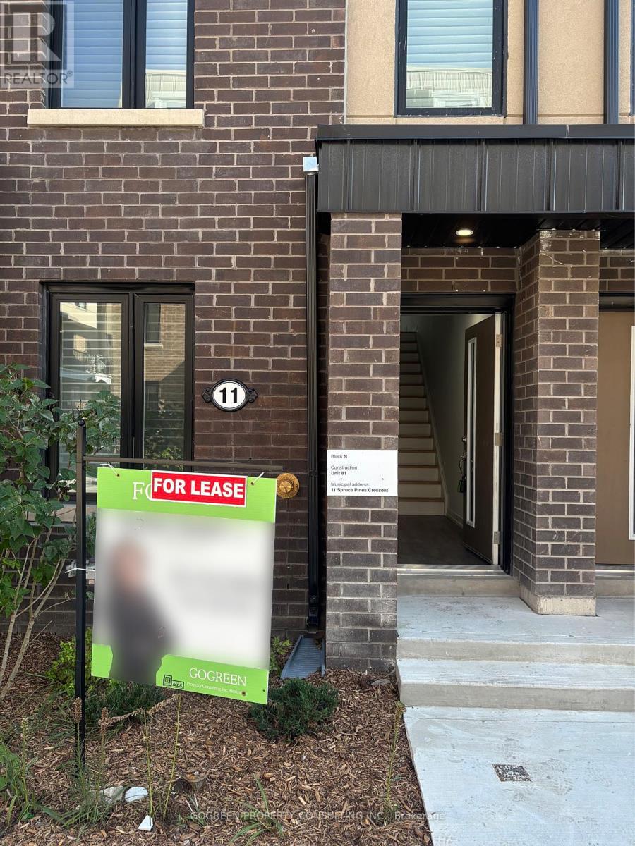 A FOR LEASE sign is in front of a brick building.