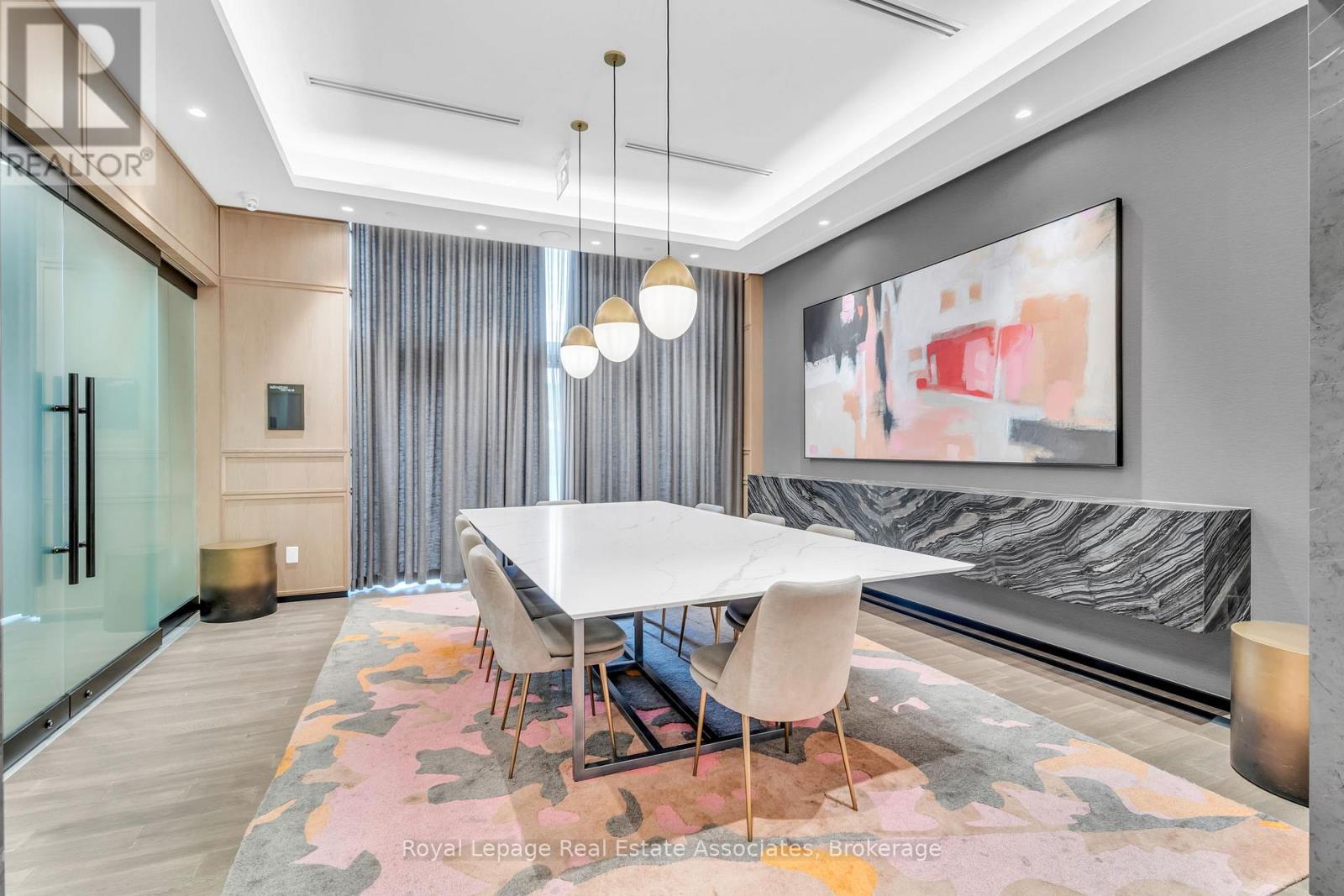 A dining room with a table and chairs.