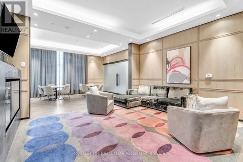 A living room with a large rug and a couch.