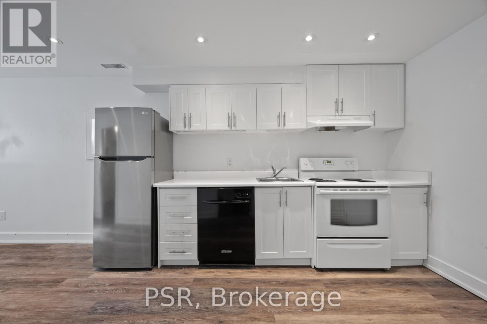 A kitchen with white appliances and cabinets.
