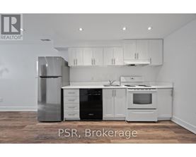 A kitchen with white appliances and cabinets.