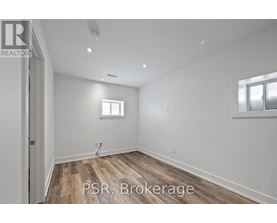 A room with wooden flooring and a window.