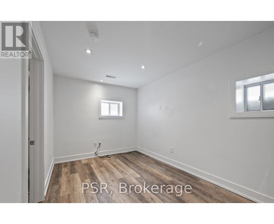 A room with wooden flooring and a window.