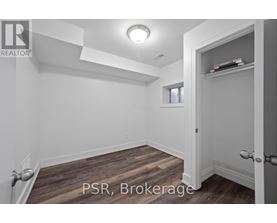 A room with a door and a window with a white wall.