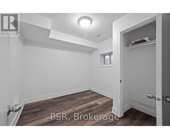 A room with a door and a window with a white wall.