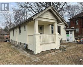A small white house with a porch is for sale.