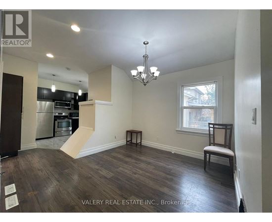 A real estate listing photo of a kitchen and living room.